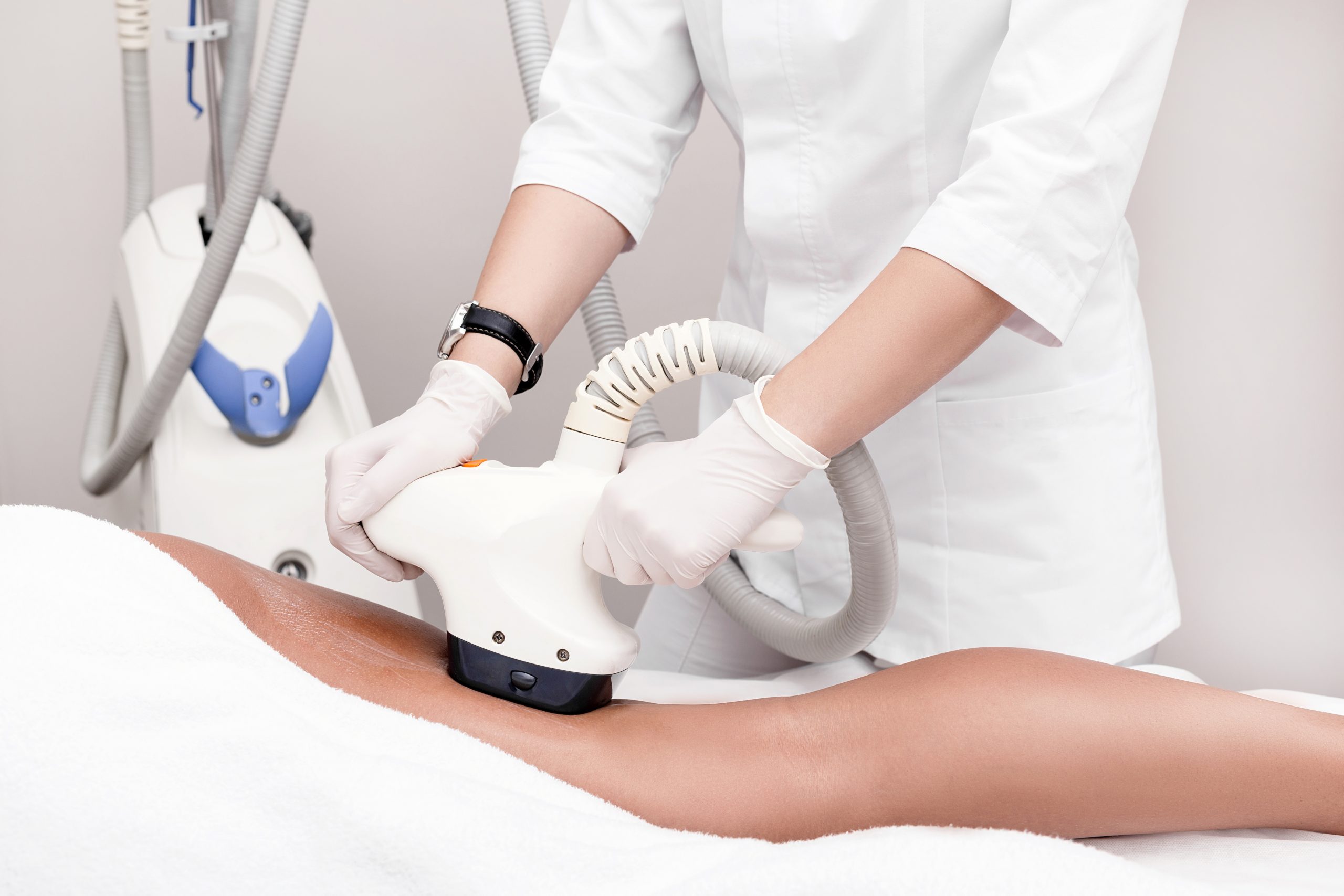 Ultrasound cavitation body contouring treatment. Woman getting anti-cellulite and anti-fat therapy on her leg in beauty salon.